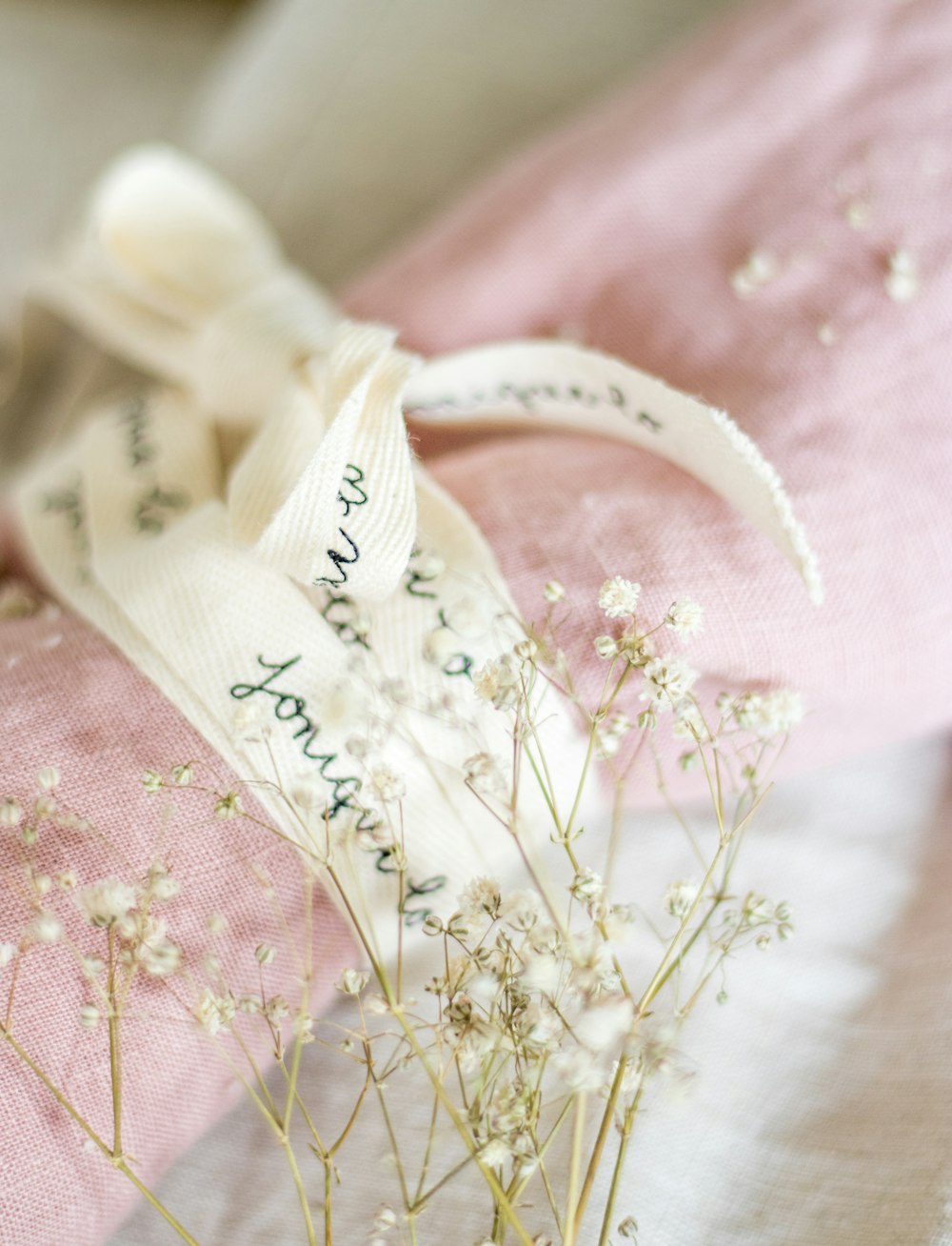 a bouquet of flowers sitting on top of a pink pillow