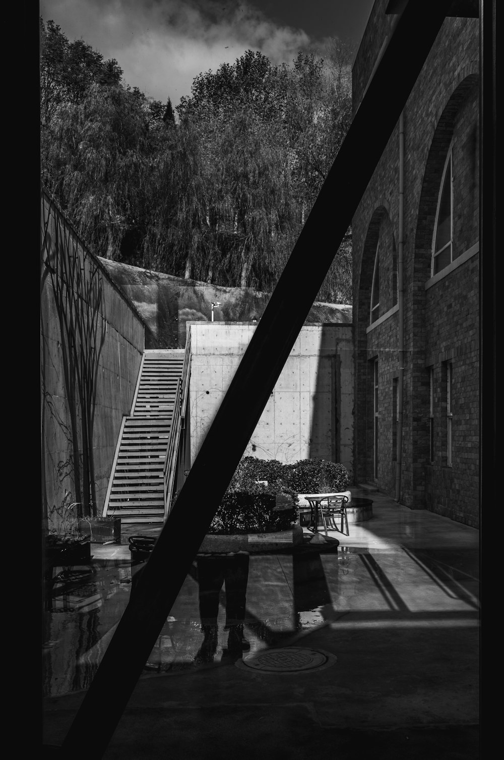 a black and white photo of a person standing in front of a building