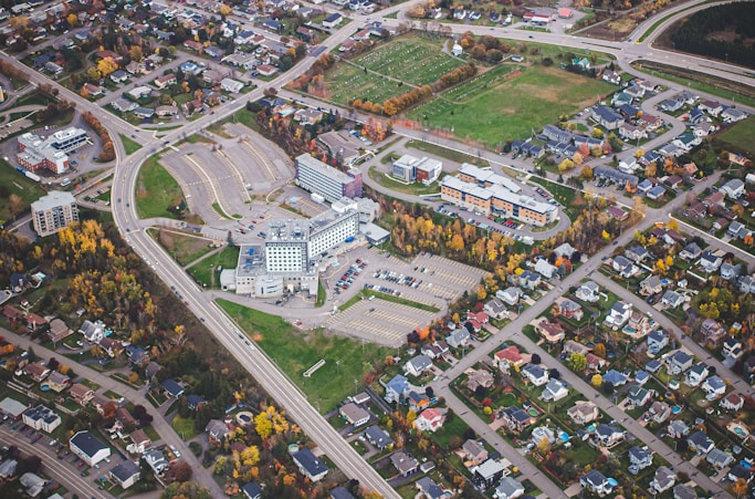 an aerial view of a large building surrounded by trees