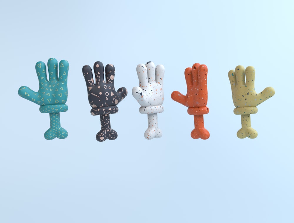 a group of five different colored hand shaped objects