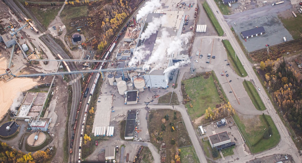 an aerial view of a factory with smoke coming out of it