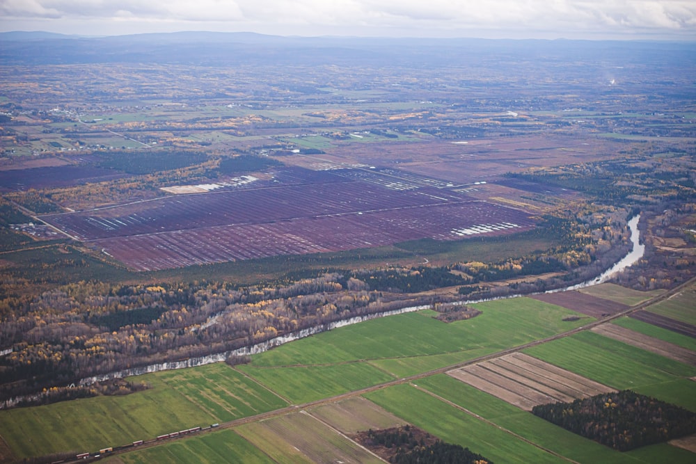 an aerial view of a field with a river running through it