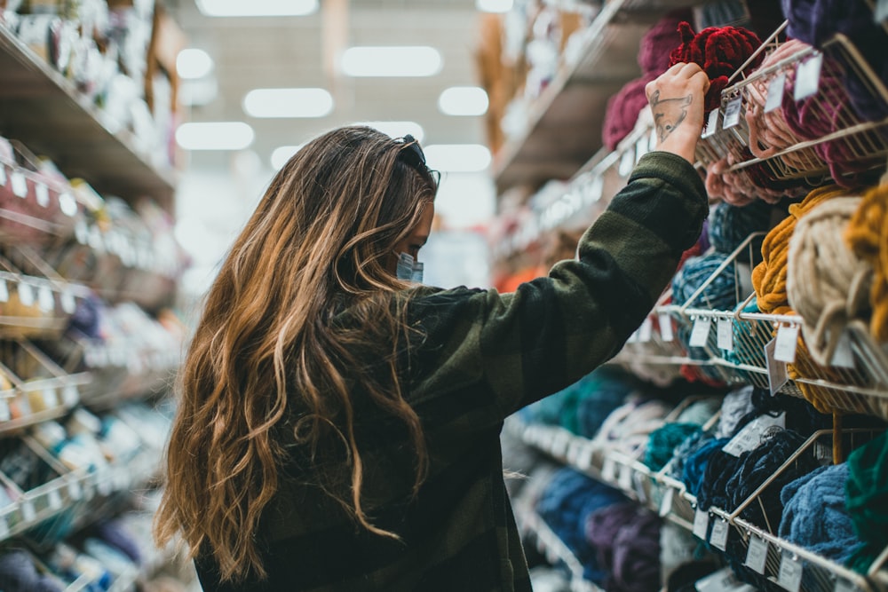 a woman shopping for yarn in a store