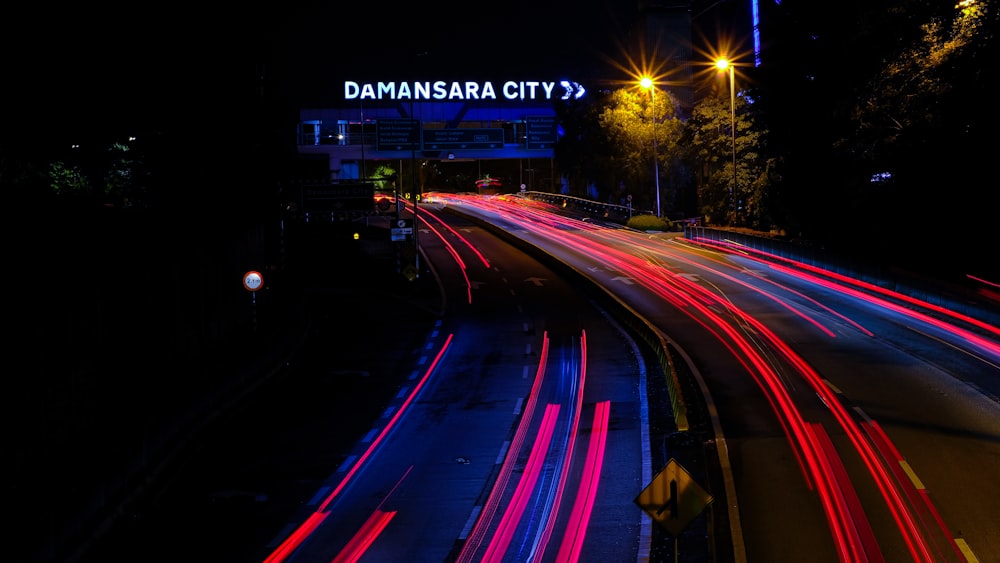 a city street filled with lots of traffic at night