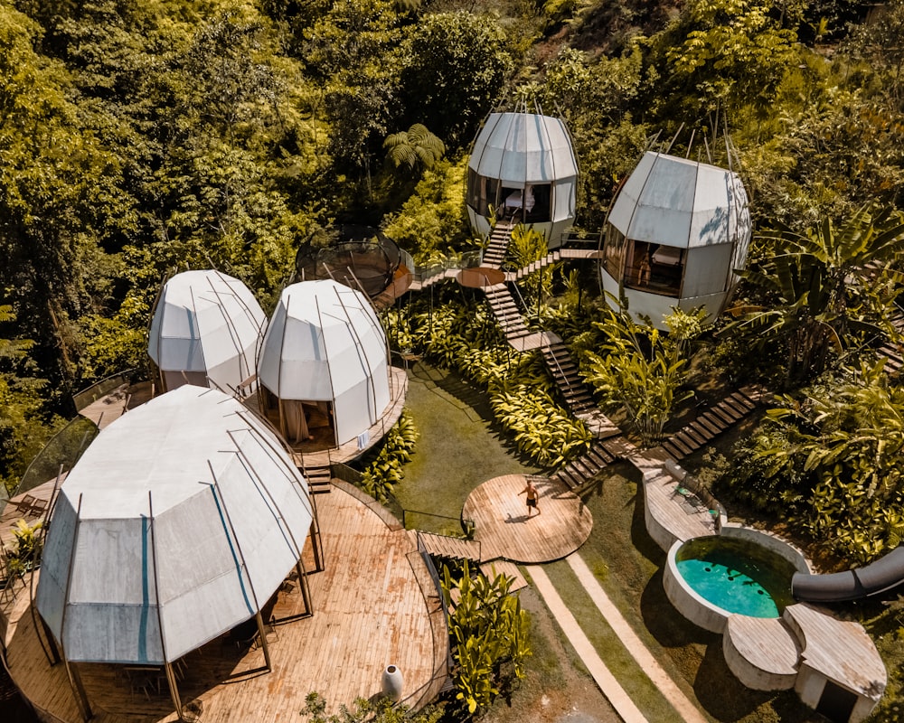 a bird's eye view of a group of tents in the woods