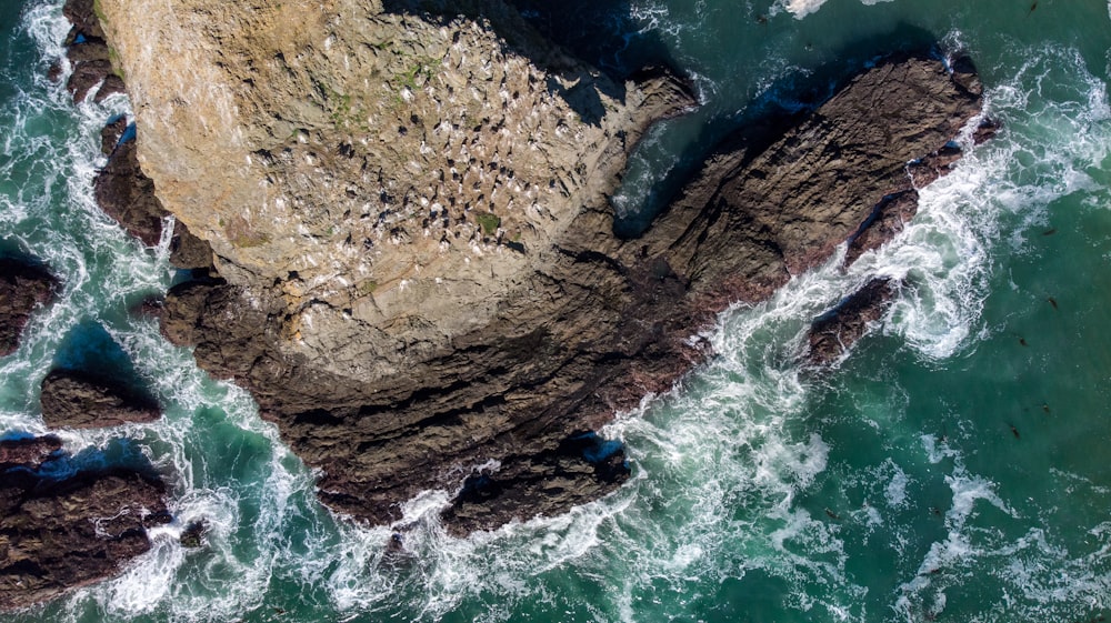 a bird's eye view of a rock formation in the ocean