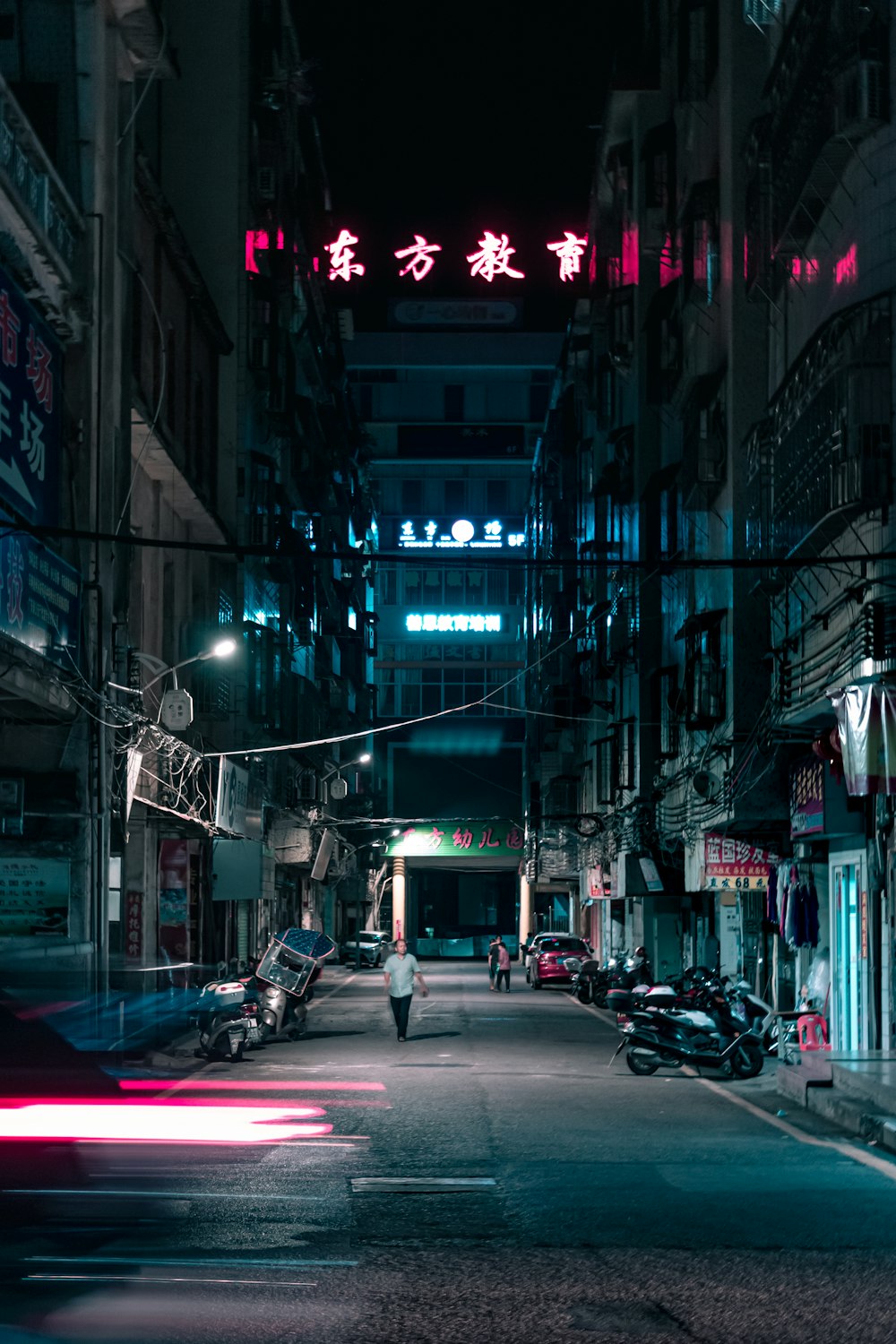 a person walking down a street at night