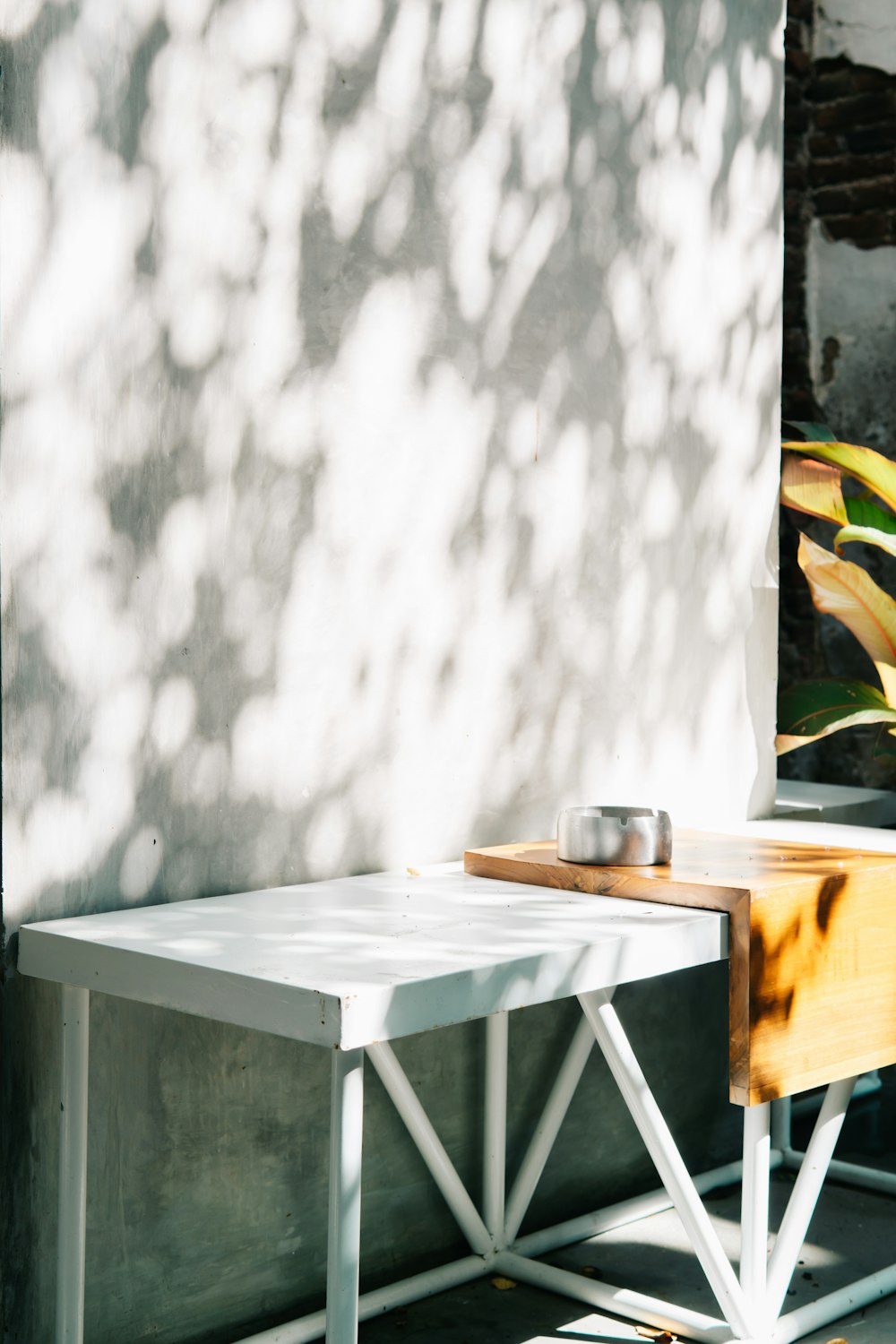 a white table sitting next to a white wall