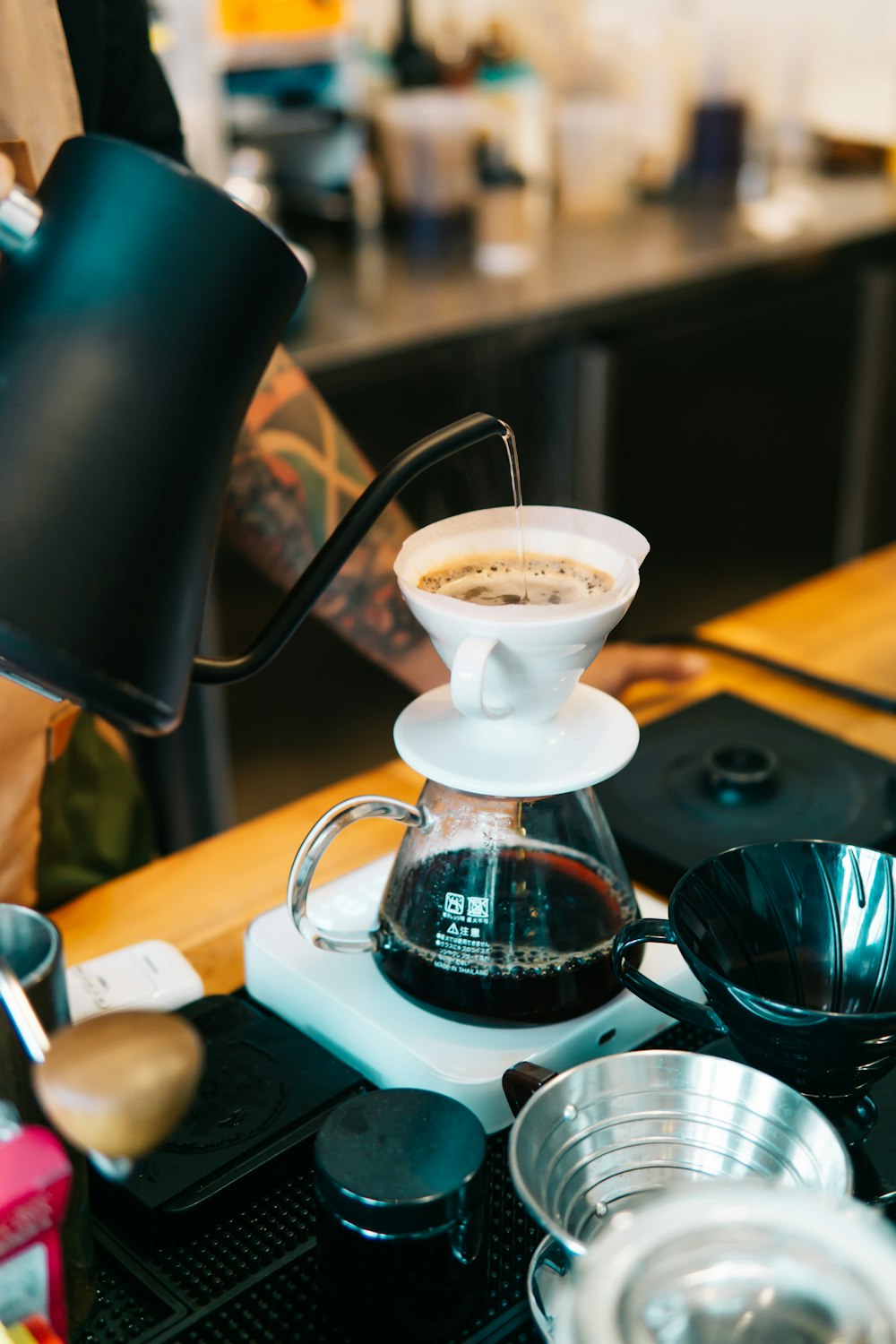 a coffee maker with a cup of coffee on top of it