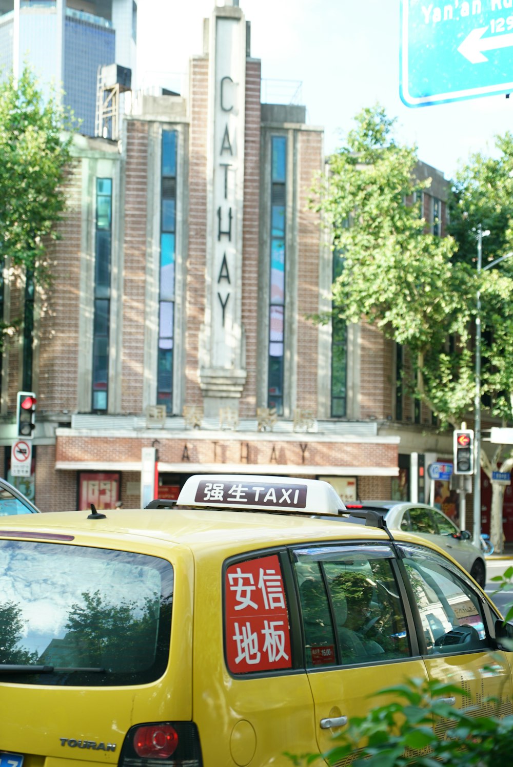 a taxi cab is parked in front of a building