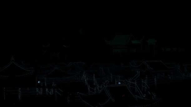 A scenic view of traditional Asian architecture with intricately designed rooftops illuminated by vibrant lights. The scene is set at night, highlighting the glowing outlines that accentuate the ornate structures under the dark sky.