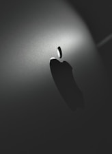 A sleek brand logo displayed on various media platforms in a stylish workspace