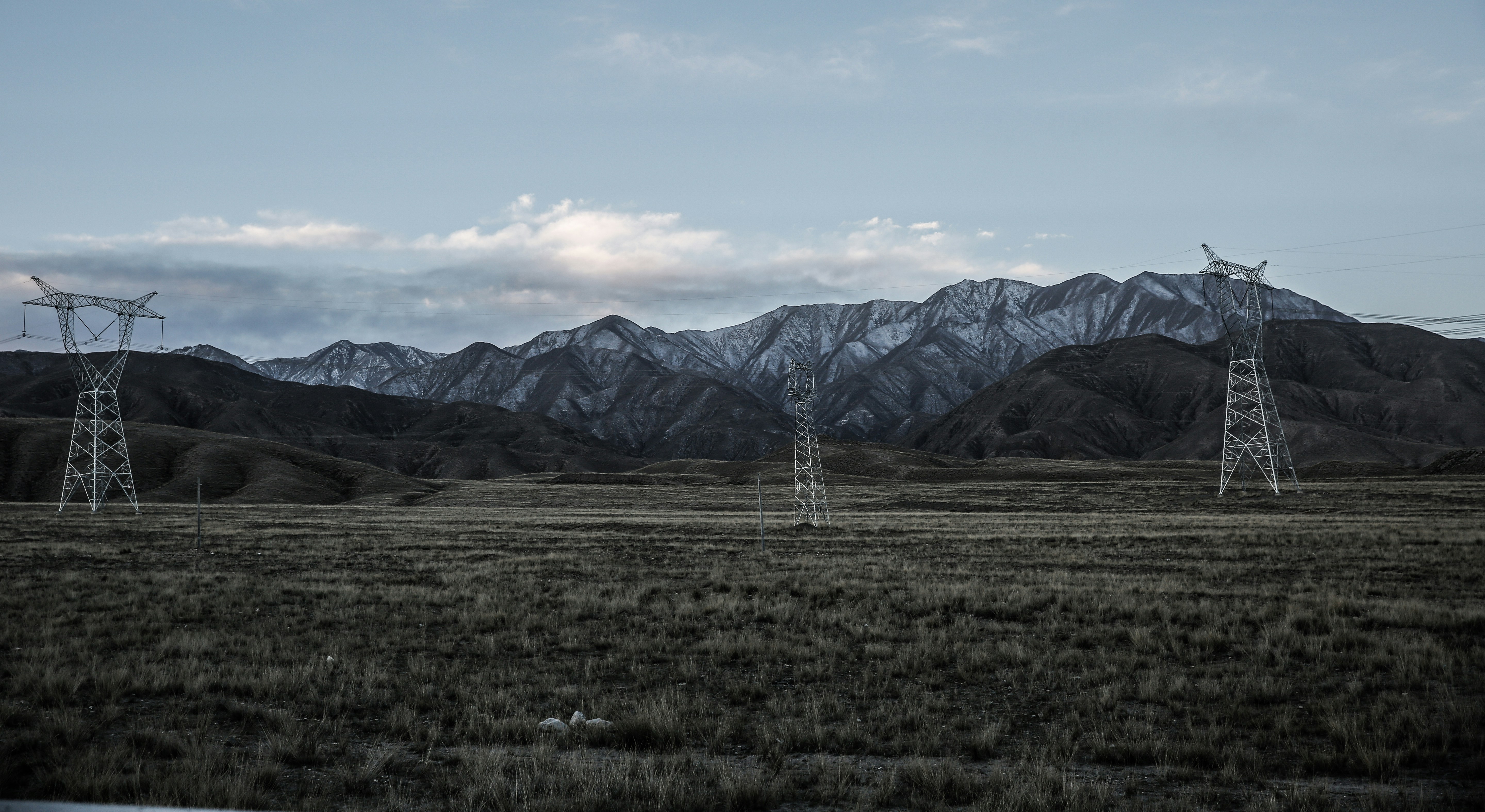 a field with mountains in the background