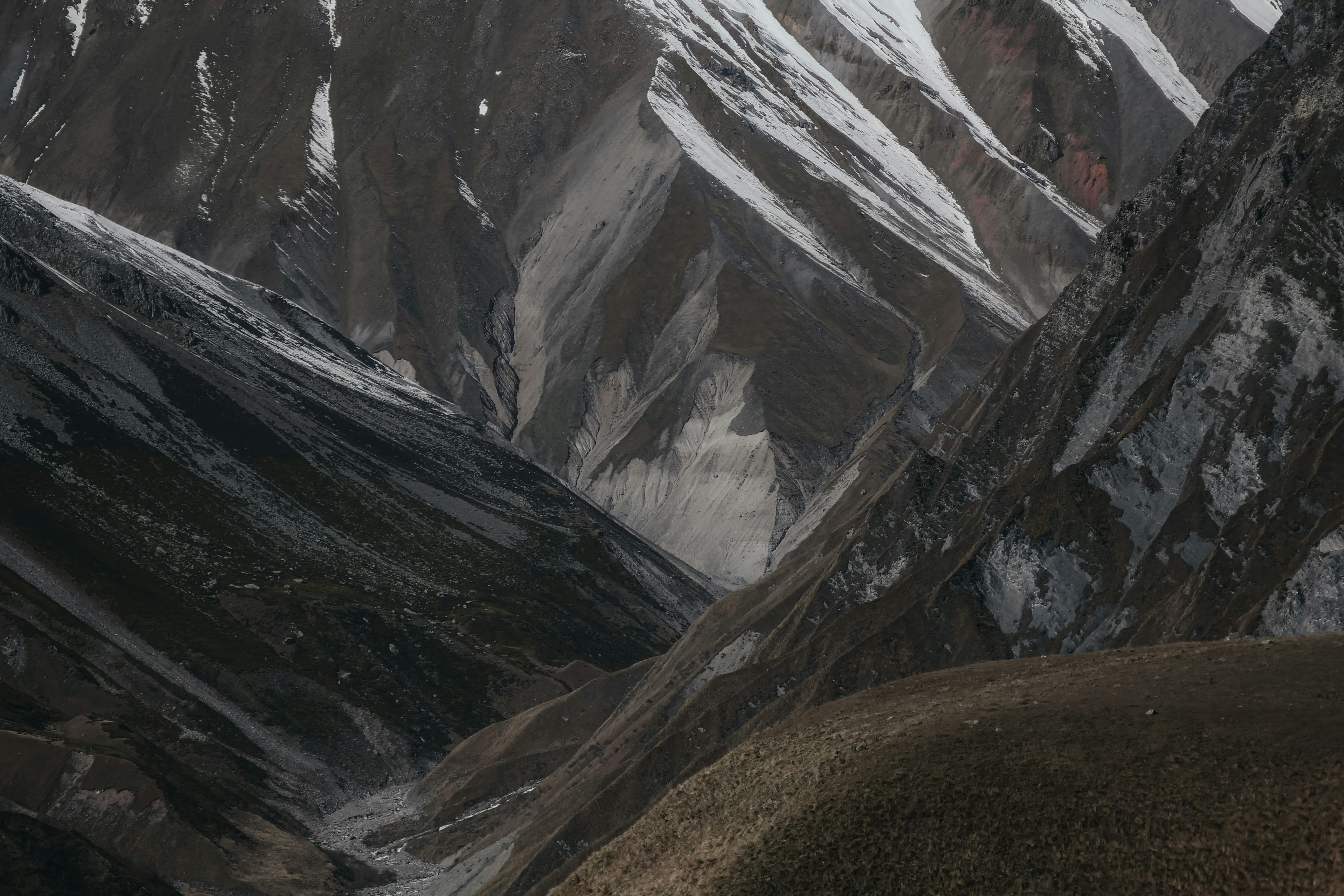 The gray mountains with snow in the fall from the viewpoint of Gudauri, Georgia