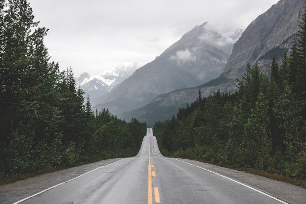 a long road with a mountain in the background