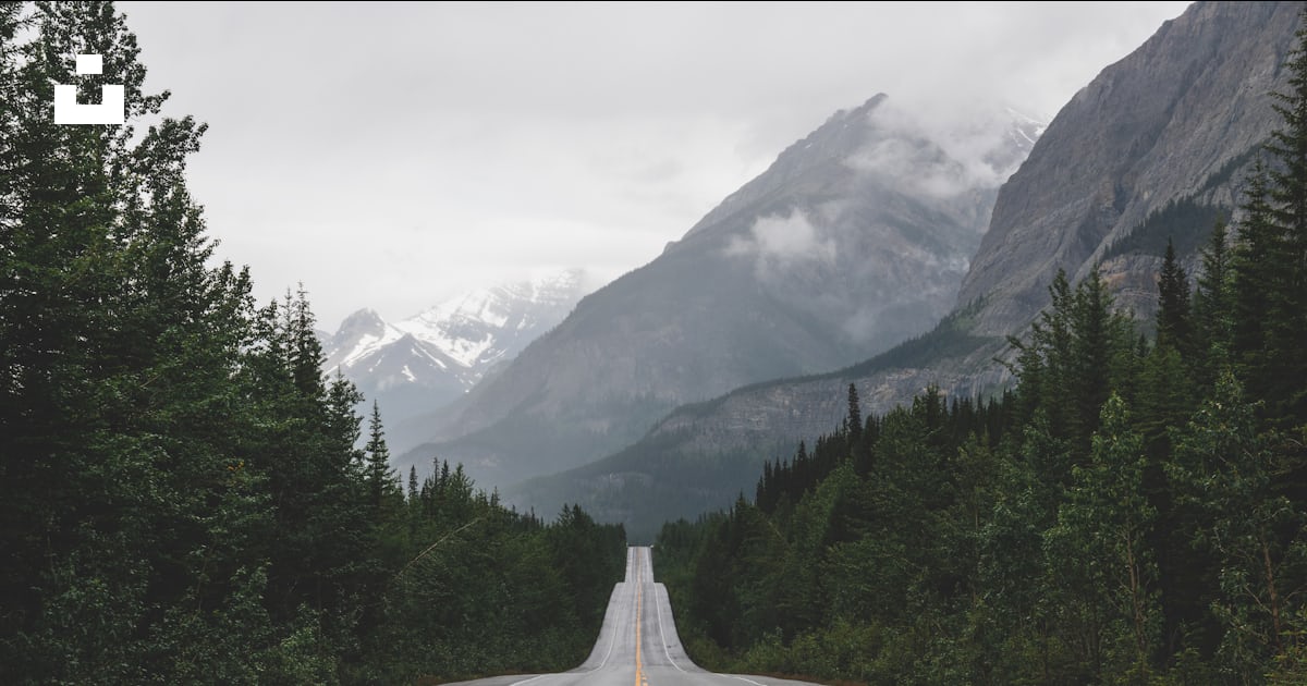 A long road with a mountain in the background photo – Free Wallpapers ...