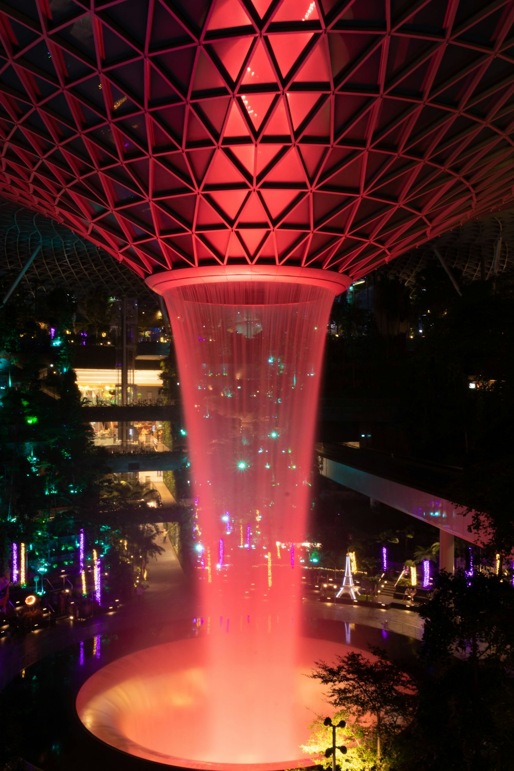 a water fountain in the middle of a city at night