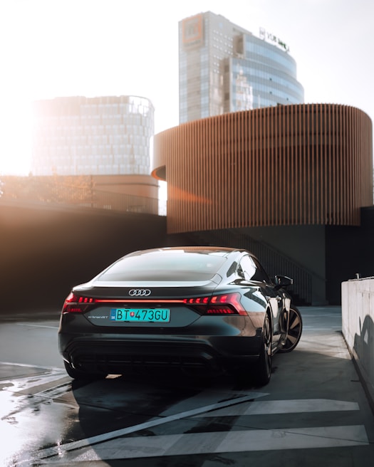 Silver Audi with polished chrome details reflecting a modern cityscape