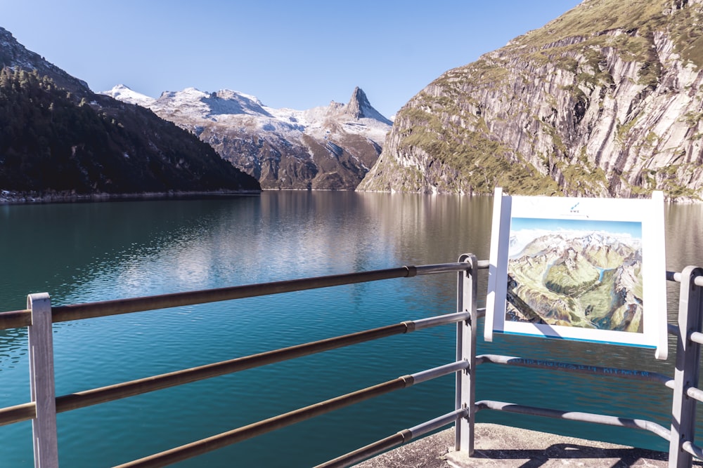 a picture of a mountain lake with a mountain in the background