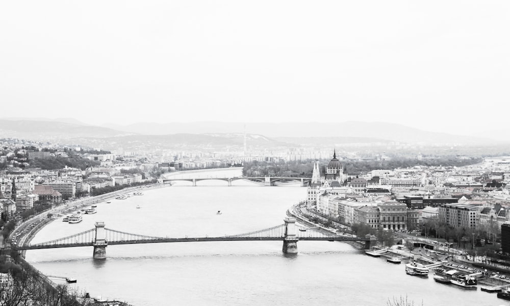 a black and white photo of a bridge over a river