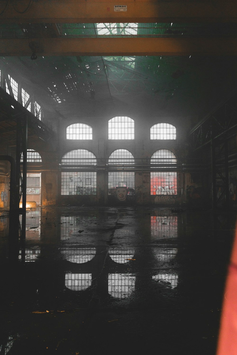 a train station with lots of windows and rain