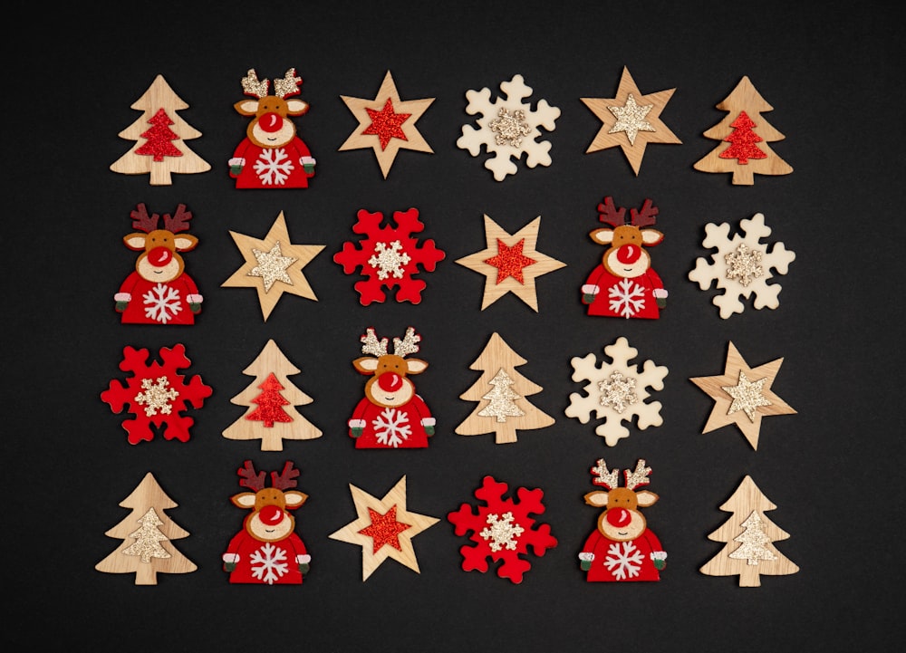 a collection of wooden christmas decorations on a black background