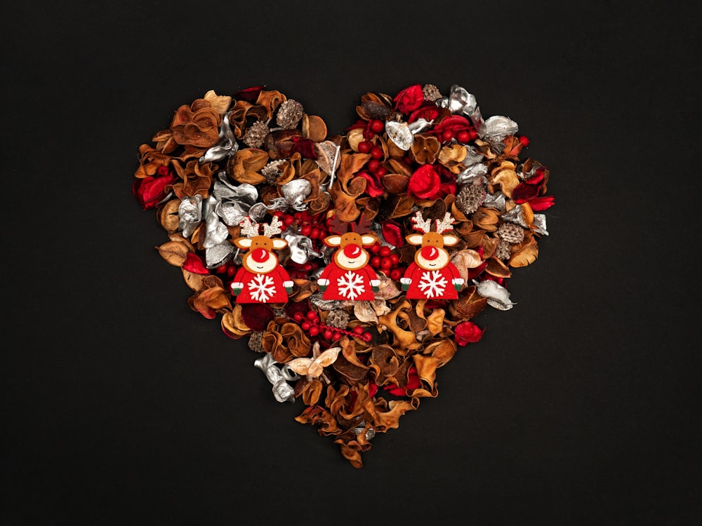 a heart shaped arrangement of flowers and nuts