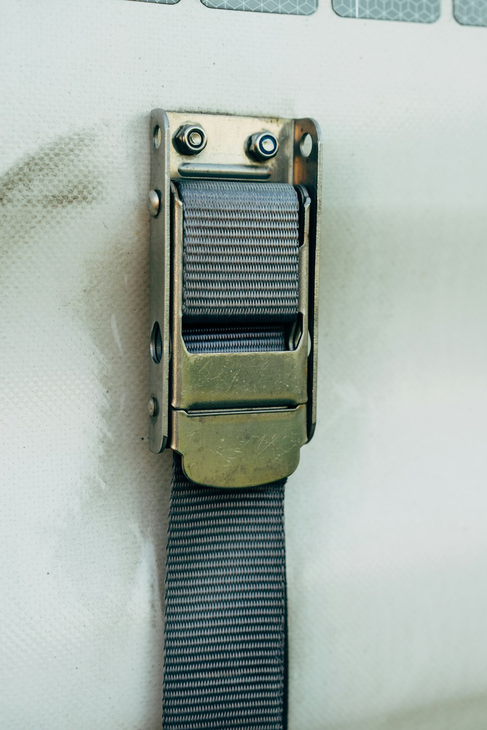 a close up of a metal buckle on a white wall