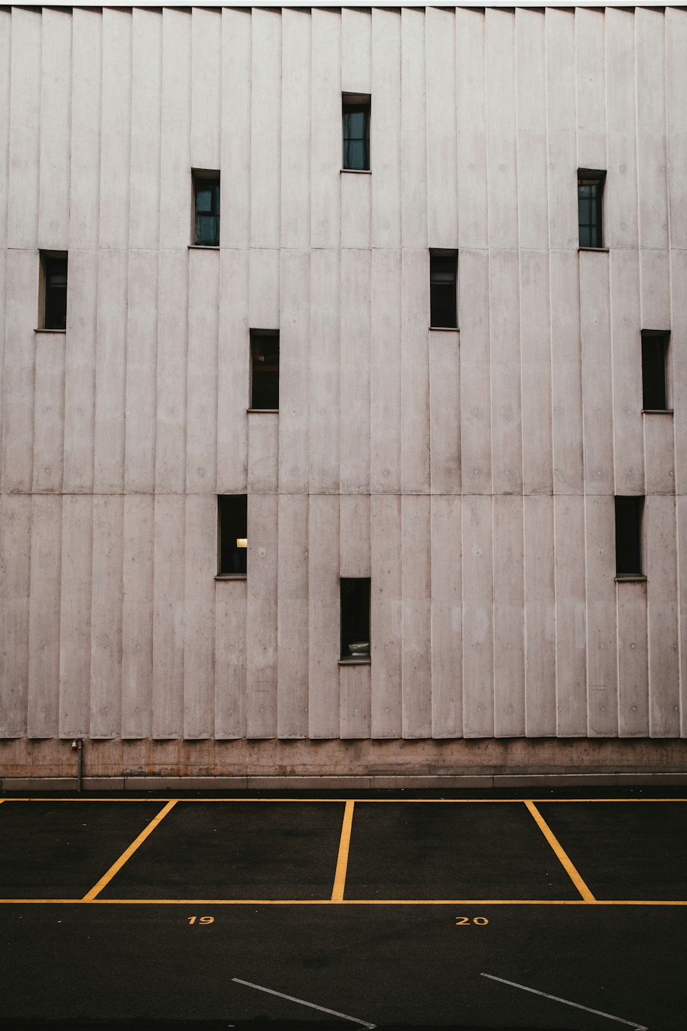 an empty parking lot next to a building