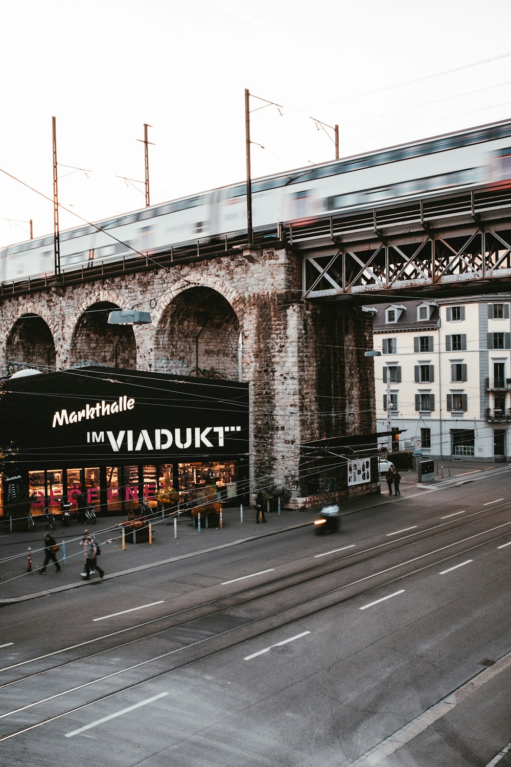 a train traveling over a bridge over a street