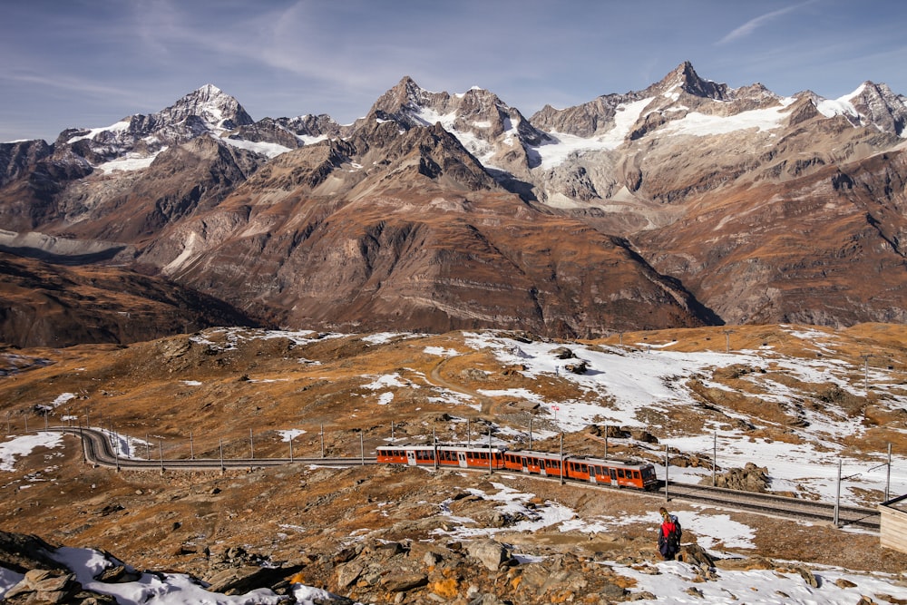 a train traveling through a snow covered mountain range