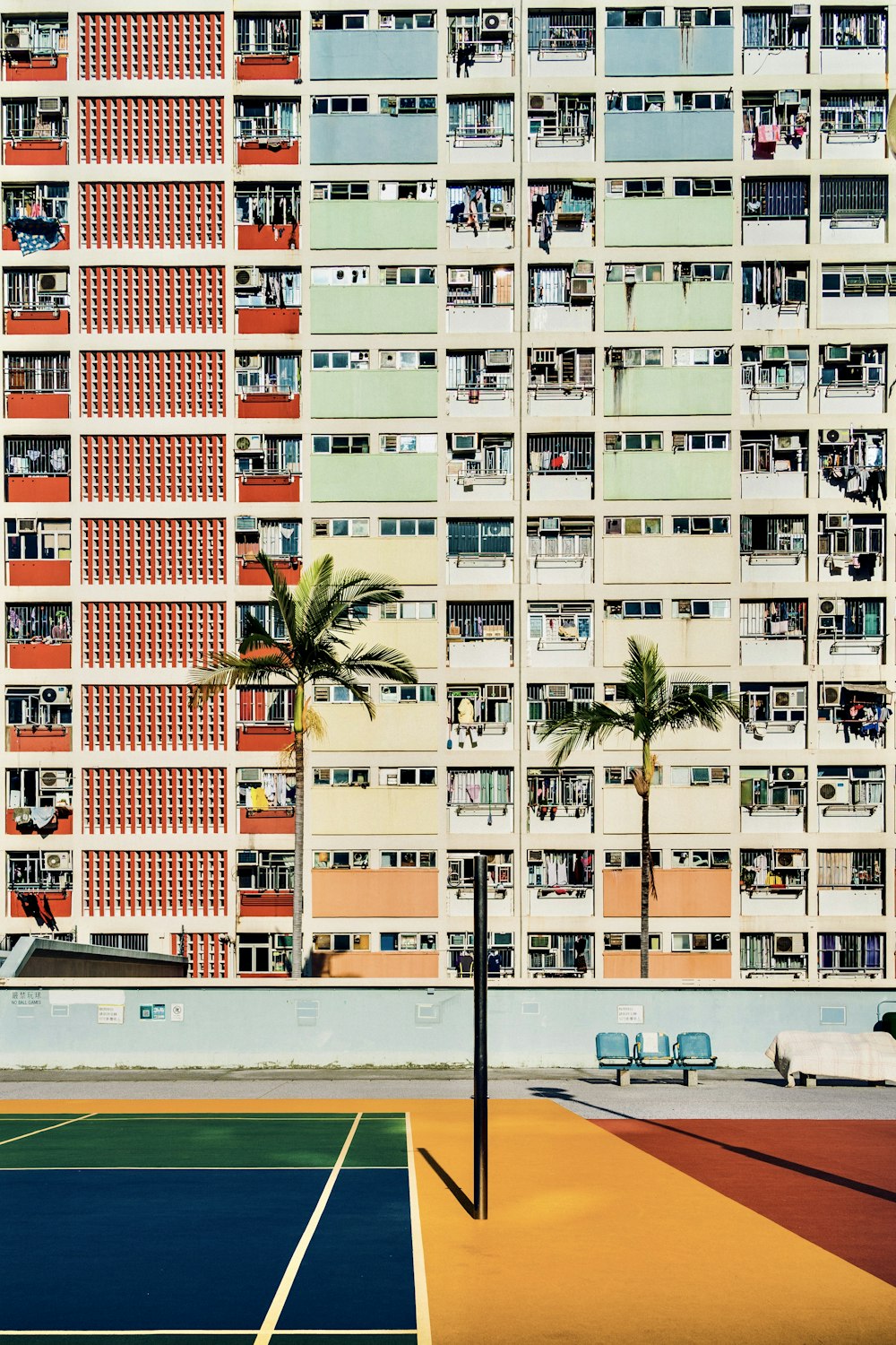 a tennis court in front of a tall building