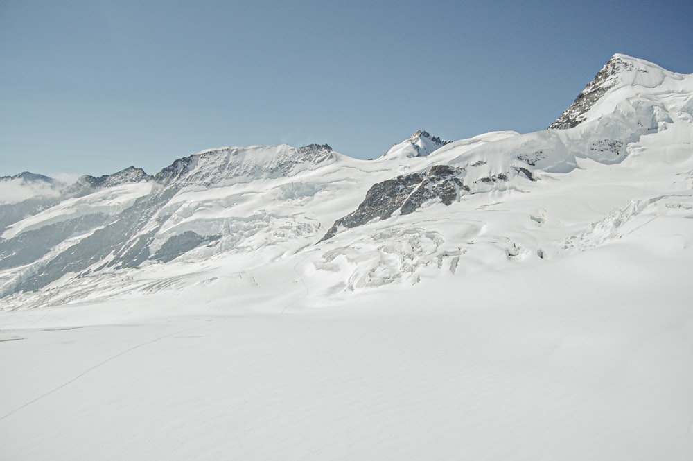 a man riding skis down a snow covered slope