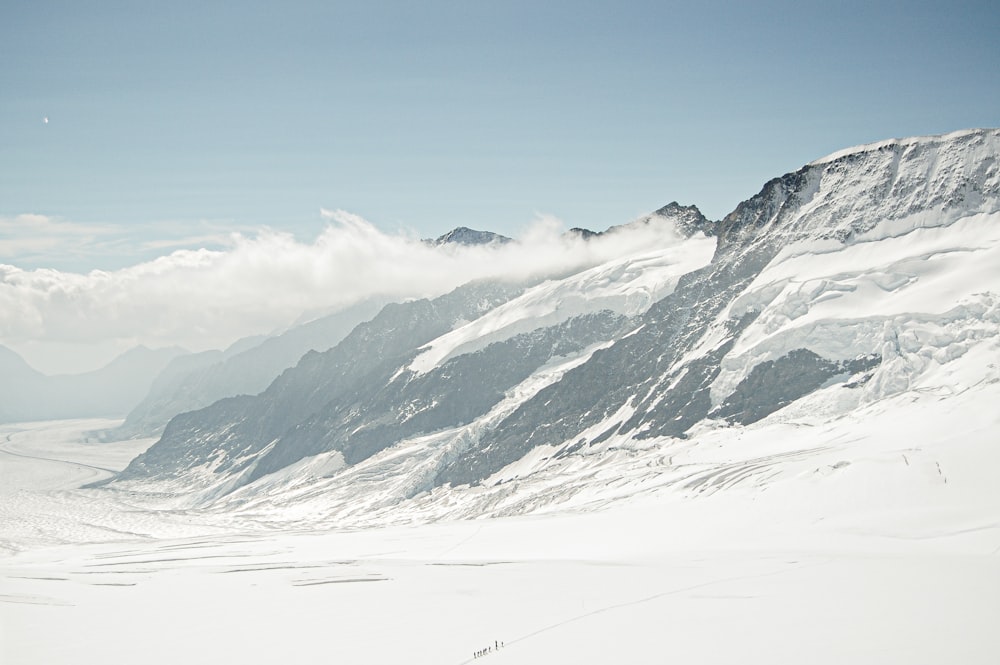 a man riding skis down a snow covered slope