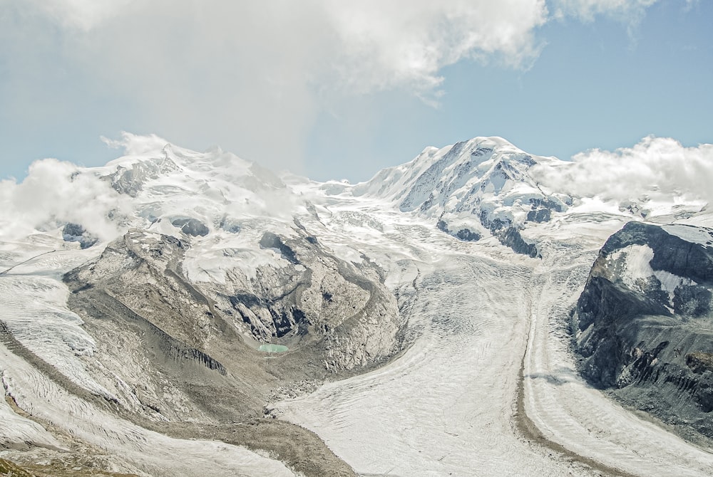 a view of a mountain range with snow on it