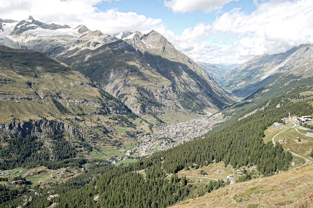 a view of a valley with mountains in the background