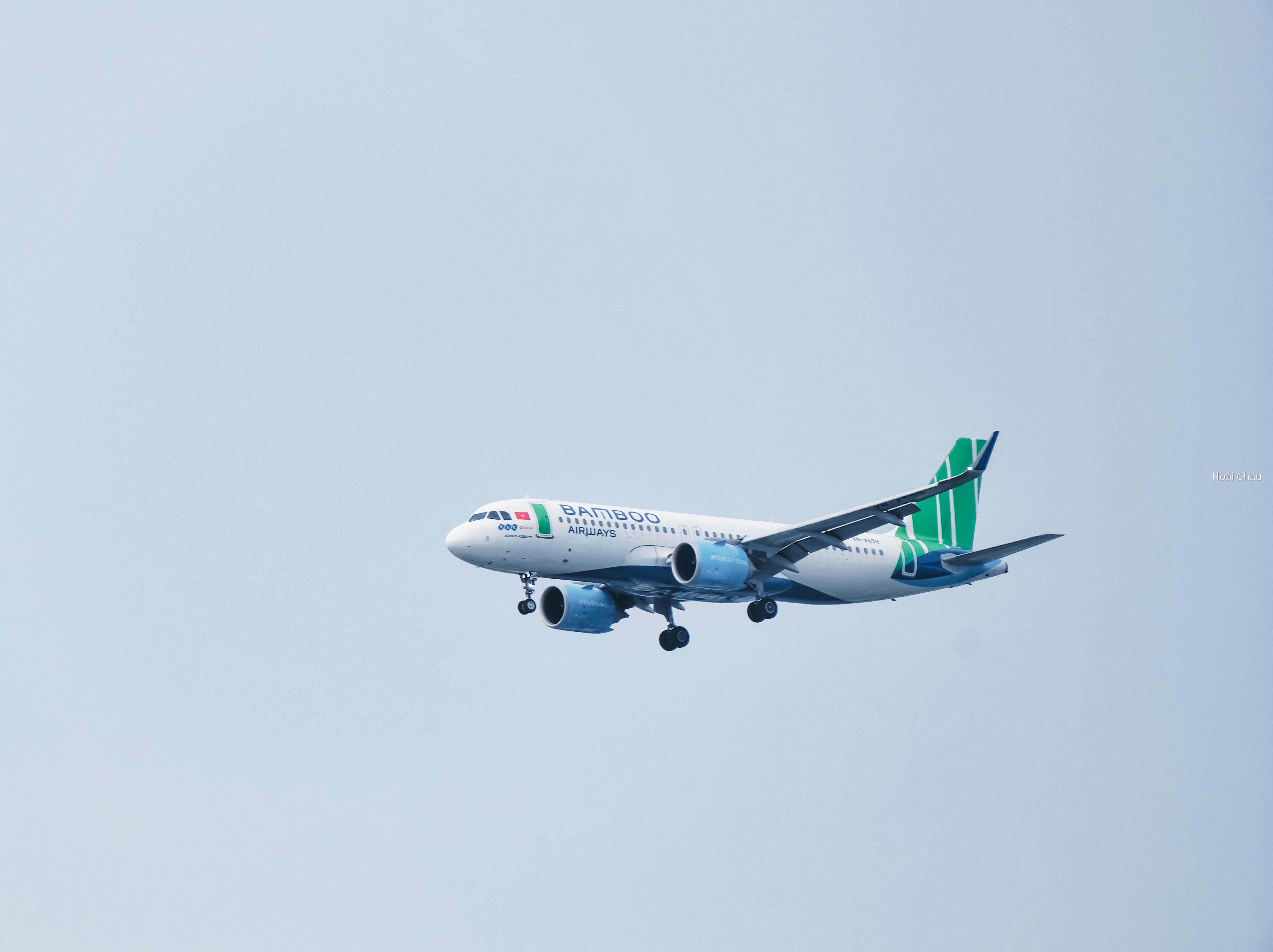 a large jetliner flying through a blue sky