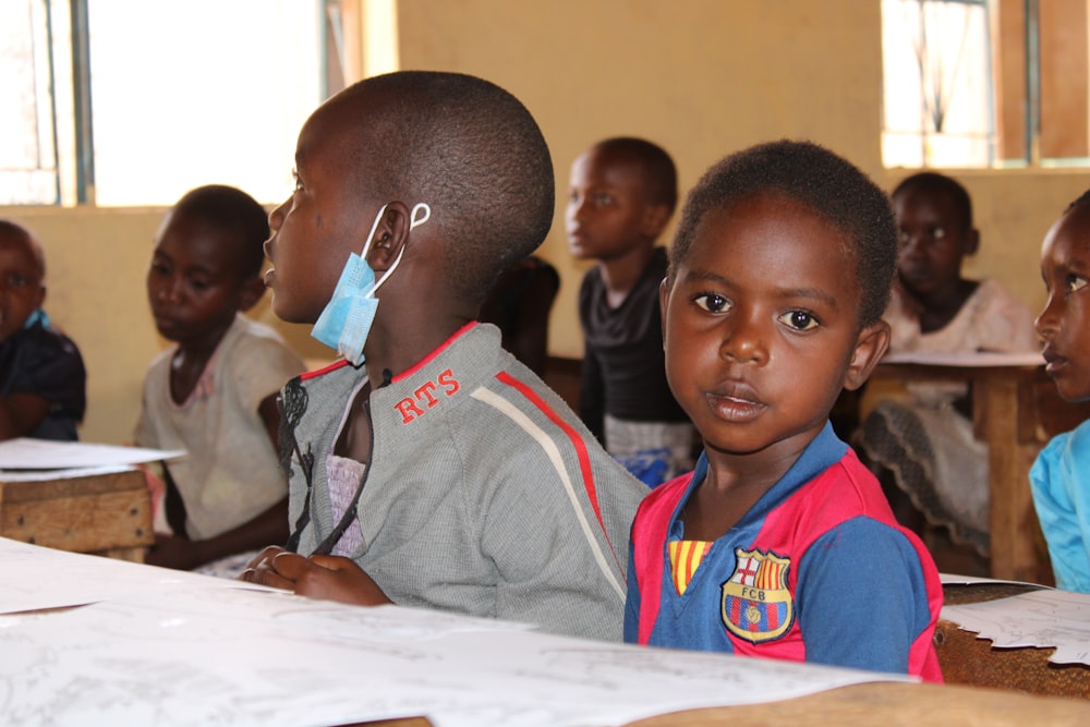 a group of children sitting at desks in a classroom