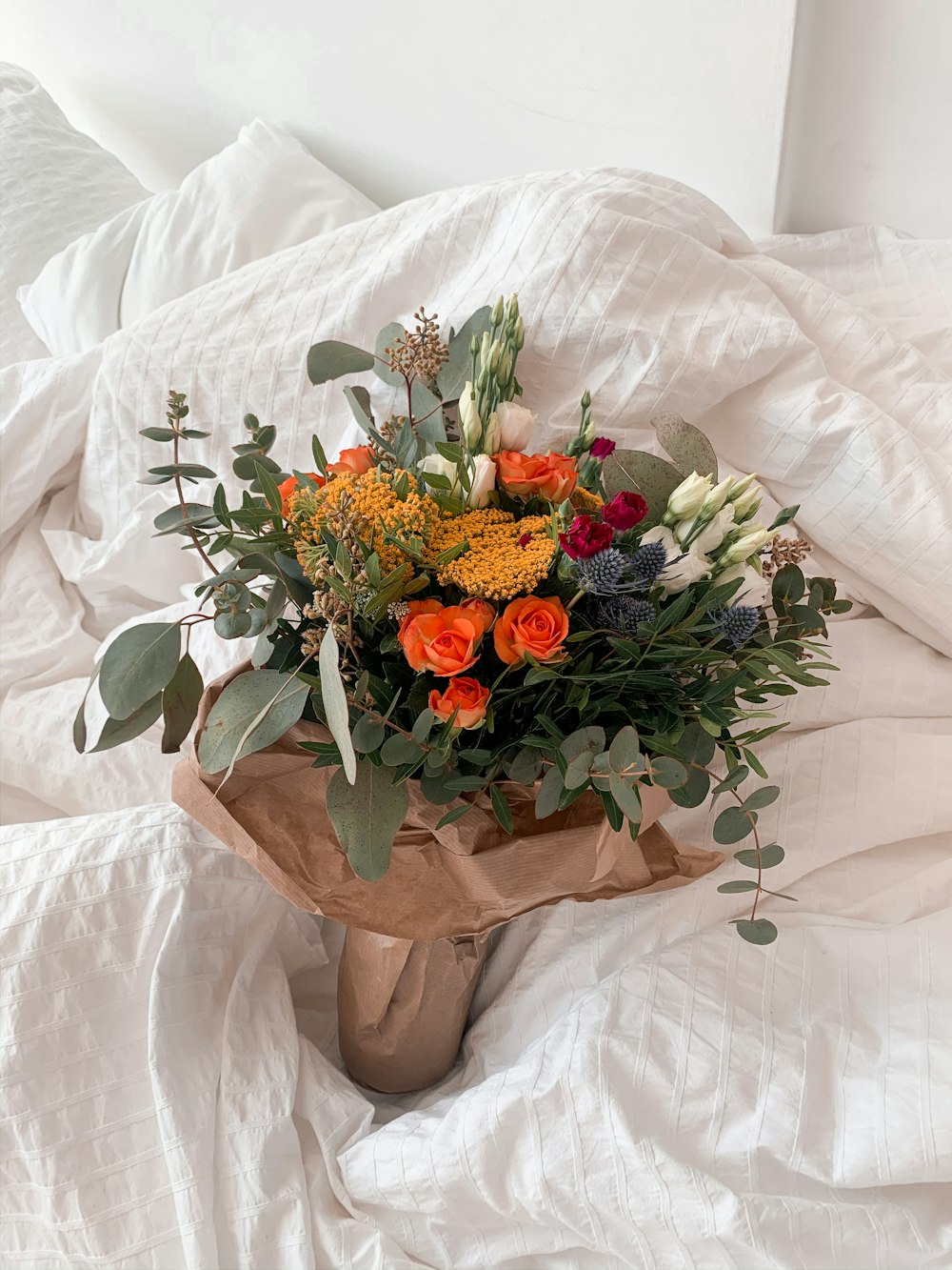 a bouquet of flowers sitting on top of a bed