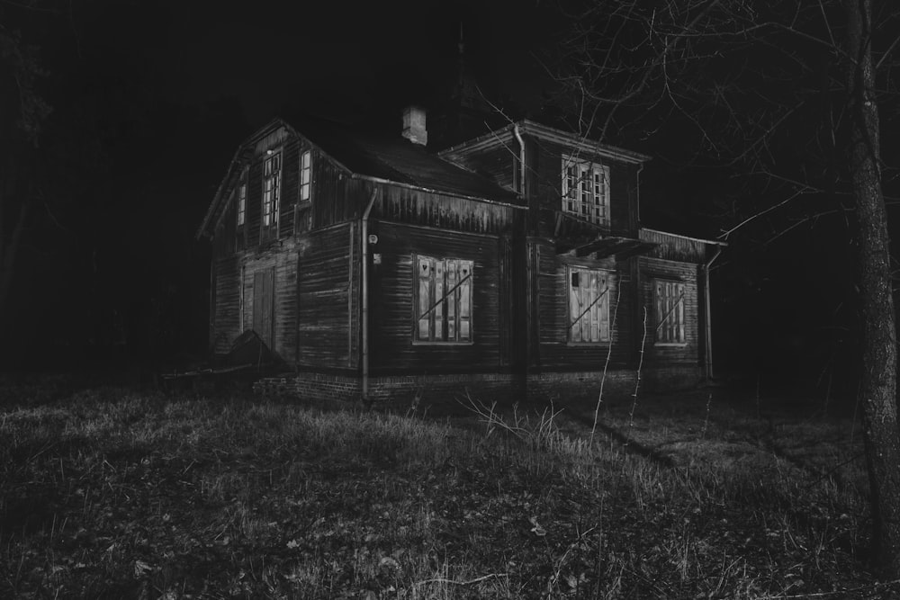 a black and white photo of a creepy house
