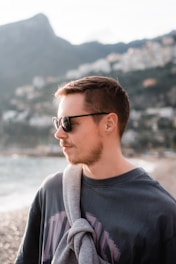 a man with a scarf around his neck on the beach