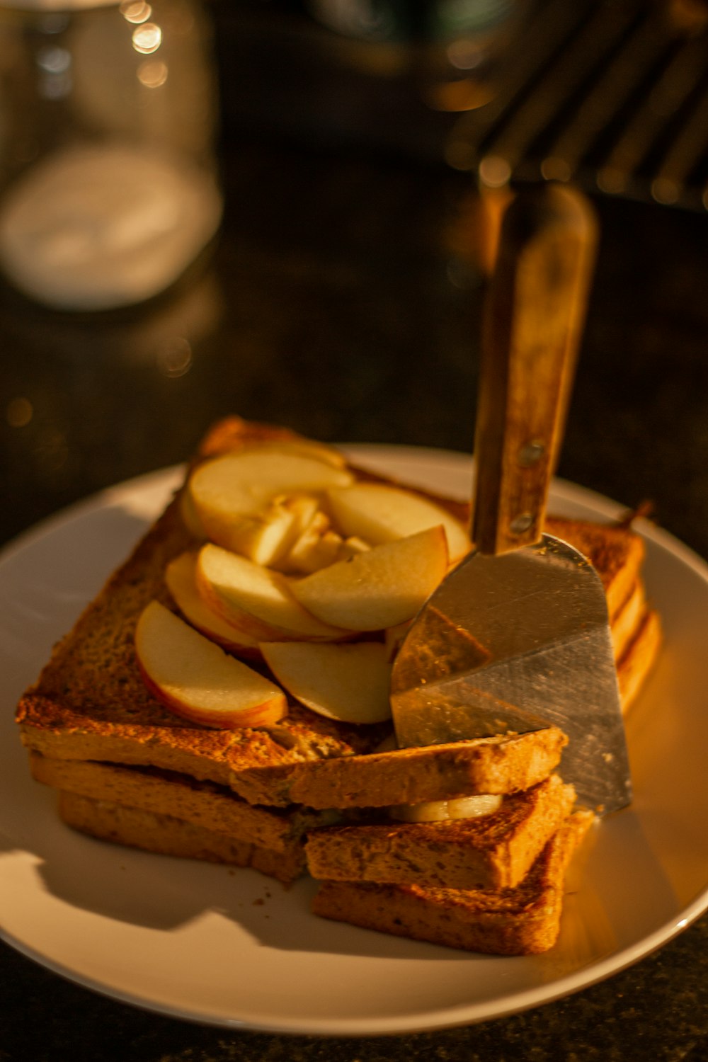 a white plate topped with slices of bread and sliced apples