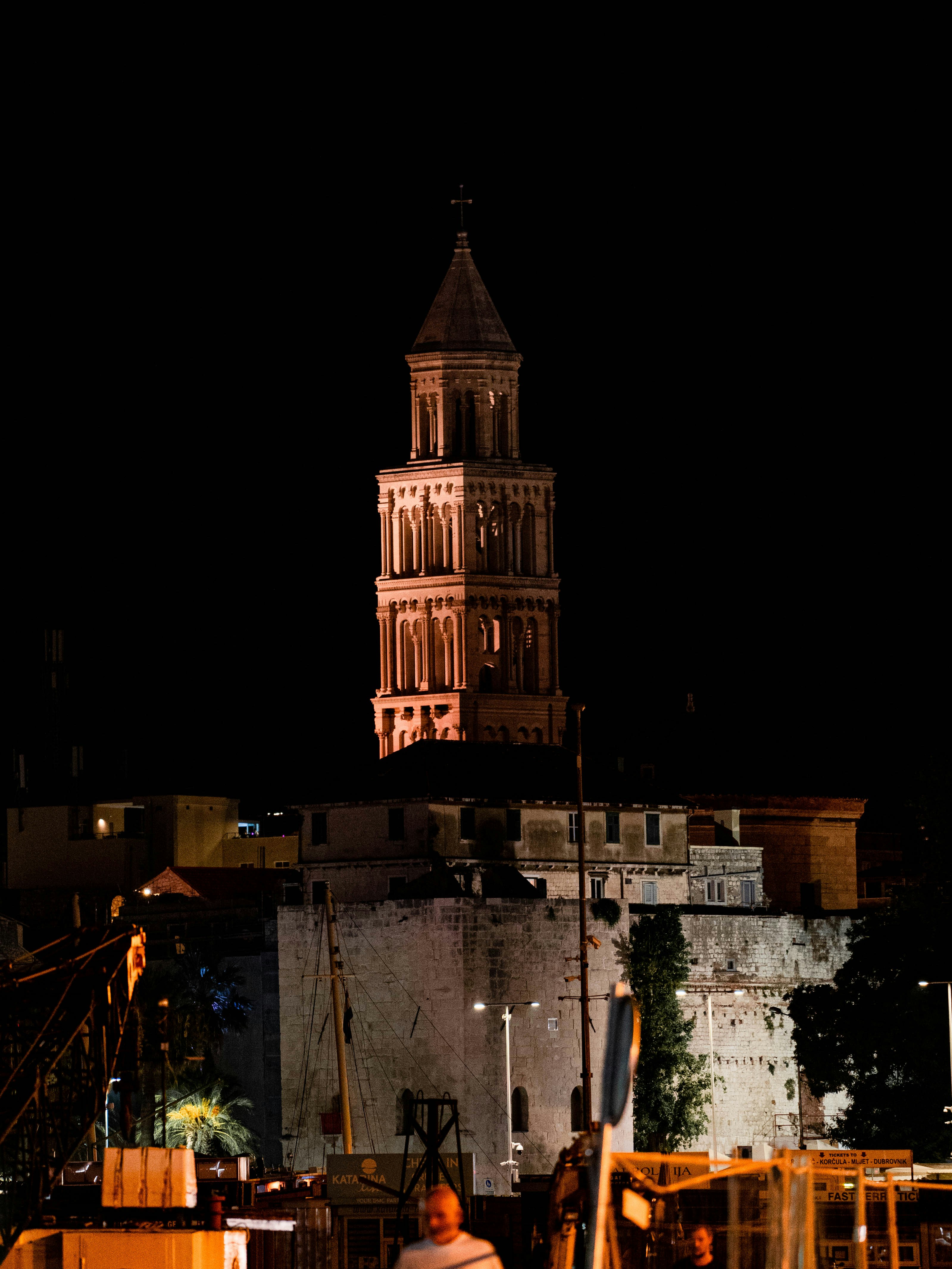 a tall clock tower towering over a city at night