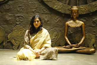 A serene image of a young woman meditating with a tablet displaying Vedic scriptures.