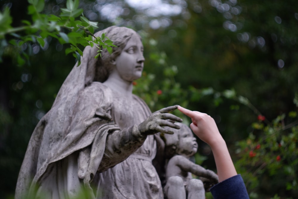 a statue of a woman holding a child's hand