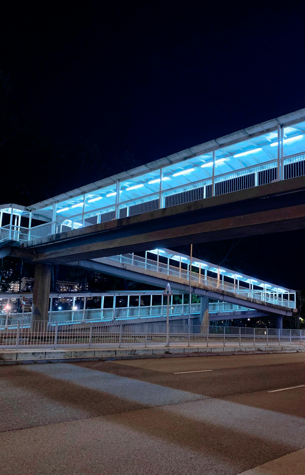 a train traveling over a bridge at night