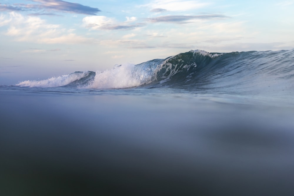 a large wave in the middle of the ocean