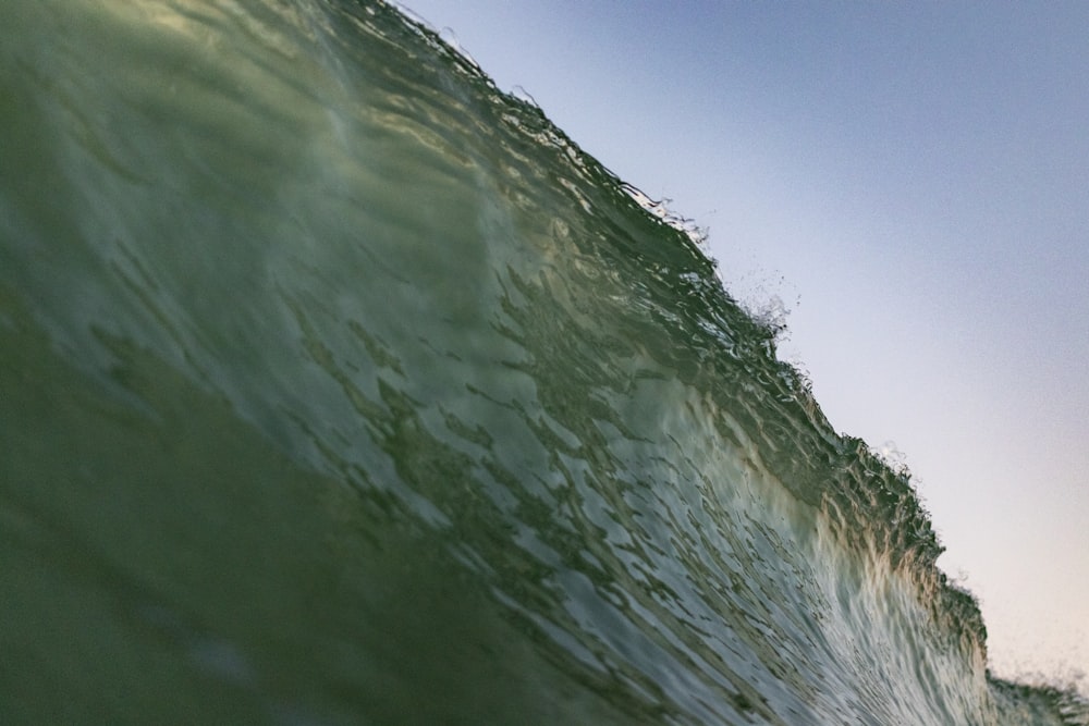 a man riding a wave on top of a surfboard