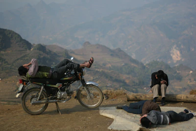 Traveler taking a break on a motorbike, enjoying panoramic views of Lang Son’s valleys and hills
