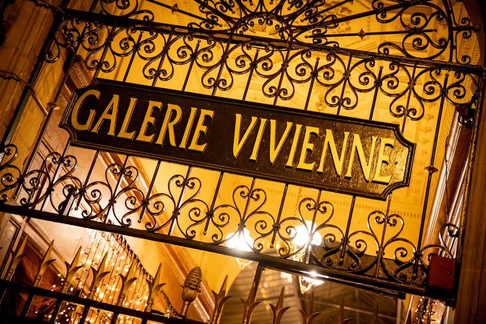 a wrought iron gate with a street sign on it